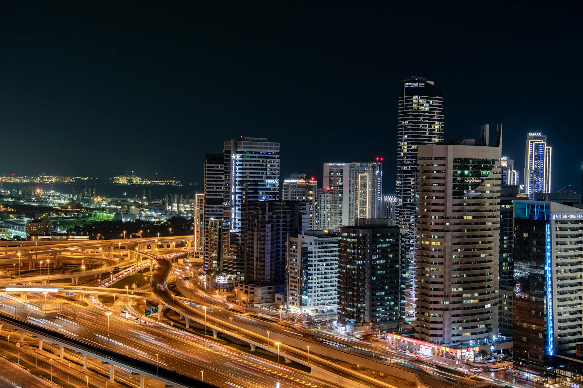 Dubai night skyline with illuminated highway interchange